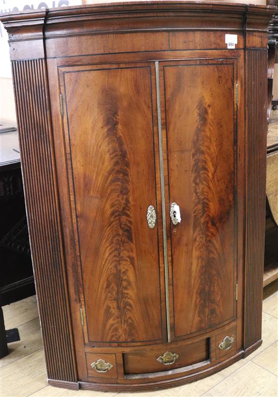 A George III mahogany bowfront corner cupboard, W.84cm